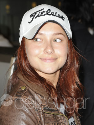  with fiery-red locks peeking out underneath her white Titleist cap.