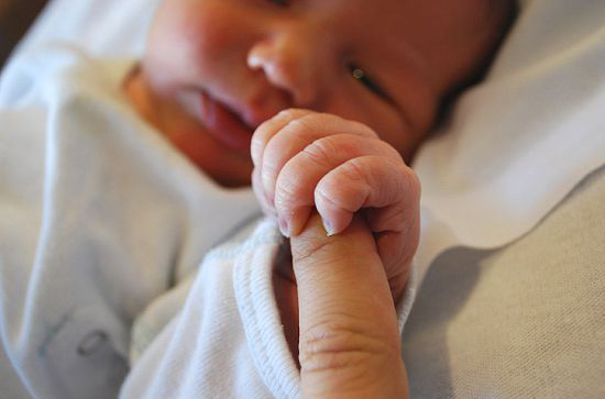 The Palmar grasp, or Darwinian reflex, forces a baby's fingers to curl 