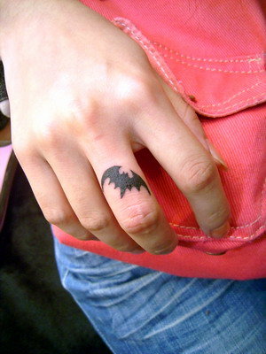 Moustache finger tattoos are a