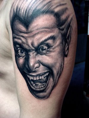 This free tattoo design is possibly a vampire's ugly smiling face (why 