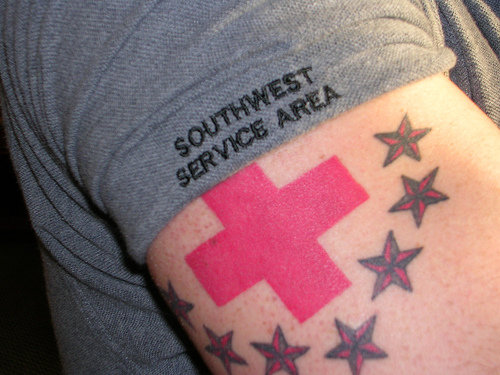 temporary red cross tattoo in the hand