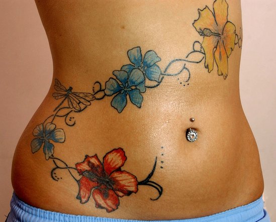 Flower Tattoo With Piercing. Permanent flower tattoo and body piercing