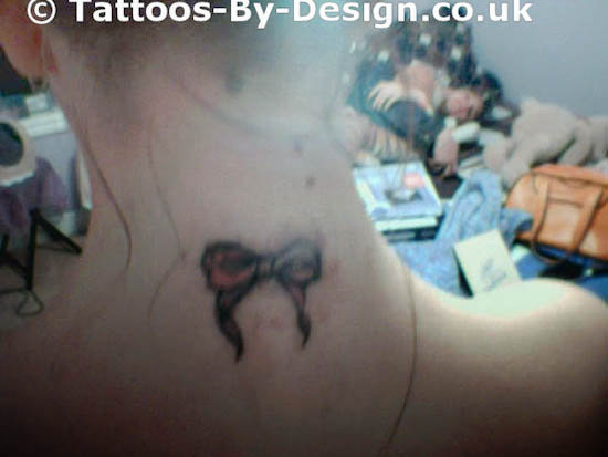 It is a tiny Sexy pink ribbon tattoo designs bow on the back of my neck and 