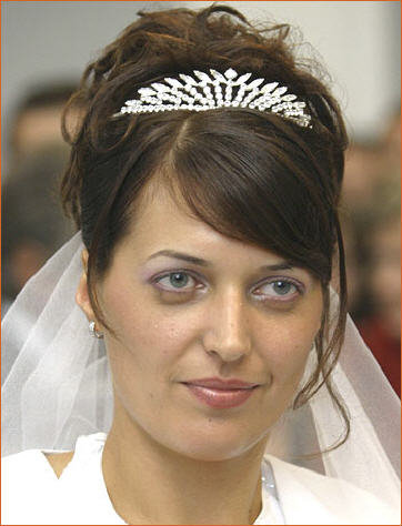  girl has made attractive wedding hairstyle and also she has wore crown 