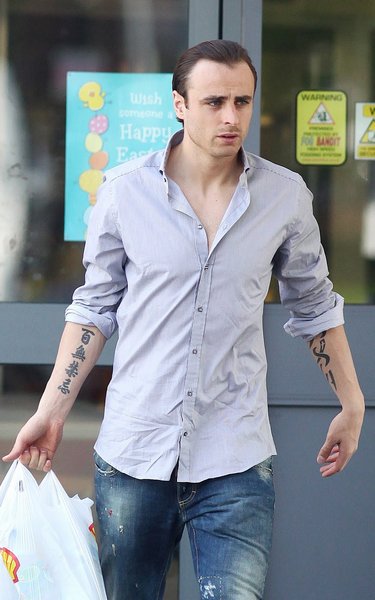 He also has a rather large tribal tattoo on his left forearm, containing a He also has a rather large tribal tattoo on his left forearm, containing a