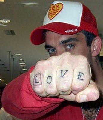Robbie Williams love knuckle tattoo.