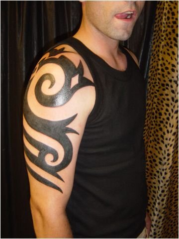 Arms are a popular part of the body for tribal tattoo designs examples 