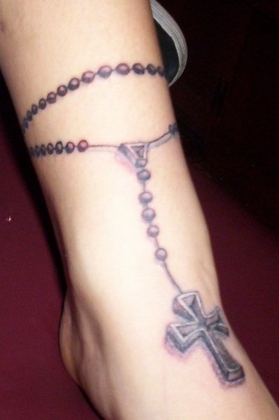 Here's a person with one of those rosary tattoos that appears almost as if