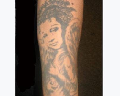 angel holding baby tattoo. house cherub angel tattoo