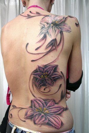 tribal tattoos on side of hand. flower tattoos on side of
