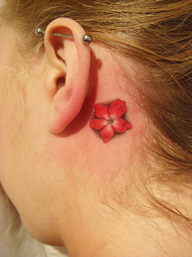 For a more tropical flair, Hawaiian flower tattoos like hibiscus, 