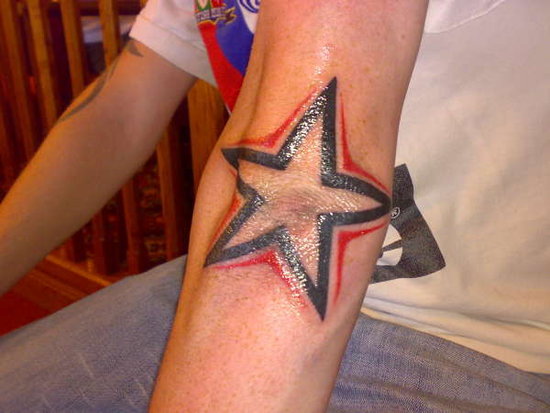 rose tattoo on elbow. rose tattoo on elbow. star