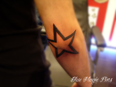 rose tattoo on elbow. Star tattoo around elbow