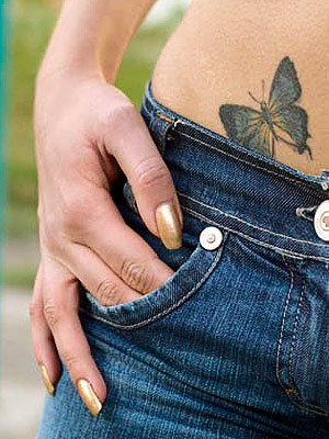 A girl with sexy butterfly tattoo on her right hip 