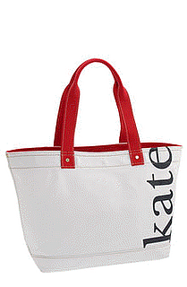 picture of white Kate Spade tote with Kate written in navy blue on the tote on a white background