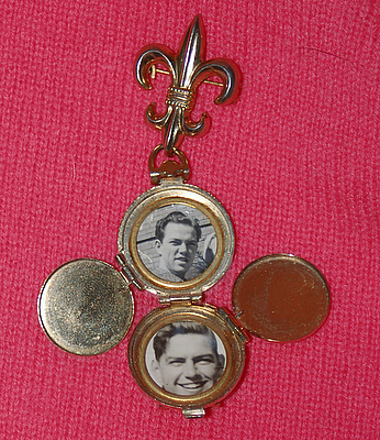 picture of a gold brooch with two pictures of men taken in the 1950s