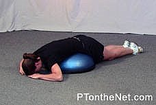 girl doing a prone spinal extension with rotation exercise