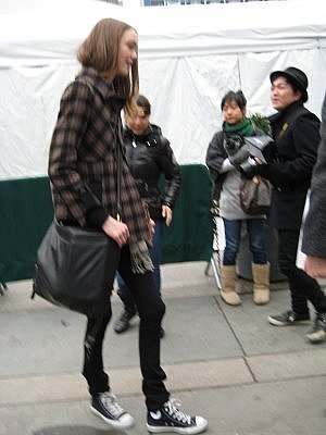 model in street clothes entering back entrance of Fall 2008 New York Fashion Week