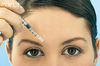 picture of woman injecting a needle into her forehead