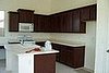 My kitchen area with beautiful cherry wood cabinets and ultra bright white walls