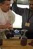 George Fritzche heats chocolate to create a "glue" for his display.