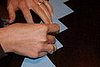 Glue or tape the two long pieces together and make a mark where you have measured your tot's noggin.