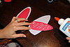Add glue to the back of the red paper.