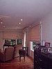 Master bedroom (after):  Galaxy roman shades in woven silk, ripplefold draperies with flat valance and kick pleats - after windo