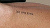 "Old Man River" on Heath's right arm. Actress Michelle Williams wrote it there, and he's had her handwriting tattooed.

