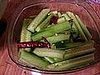 Put the cucumbers and hot peppers into a jar or large sealable vessel.