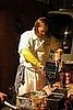 Wylie slices up pork at the David Chang party. 