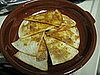 Layering the baked tortillas in a cazuela.