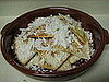 Topping with cheese. 