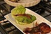 Rocco taught me how to assemble one of David Chang's lettuce wraps: fill the lettuce with the Korean barbecued beef, top with ki