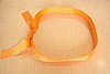First, make a loop with the ribbon and tie a knot. You will start to place the folded diapers in the ring. 