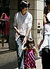 Katie and Suri Stride Down the Sidewalk
