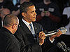 Obama holds a souvenir bolt presented to him by an employee following the tour.