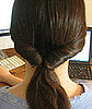 Pull ponytail outwards to tighten.