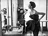 Dorian Leigh, dress by Piguet, photograph by Richard Avedon, Helena Rubenstein's apartment,
Paris, 1949.
