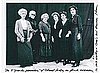 Karl Lagerfeld with Chanel seamstresses costumed as women working in Chanel's hat business in 1913.