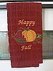 fall-themed kitchen towel on the oven door (Kohl's)