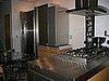 We added stainless countertops, painted the walls a warm greige color and added in beautiful swiss pear cabinetry from Bulthaup.