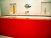 Our fab red glass tub with inset marble cubbies.