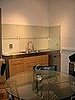 Opposite the Dacor fridge is the sink. We placed a round glass table in the middle to bring the room together. 