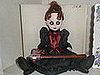 Creepy little doll in the bookcase in Lizzie's room.