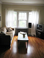 Left side of living room facing the windows